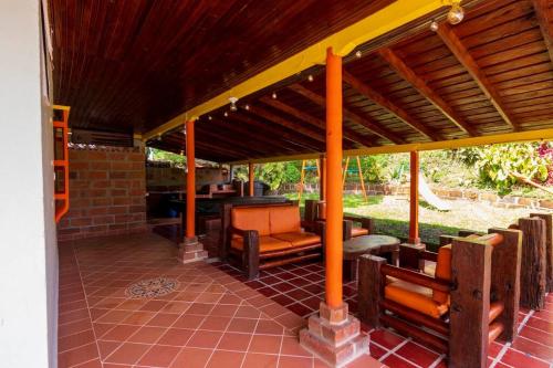a pavilion with a table and chairs on a patio at Finca los Juanes in Jardin