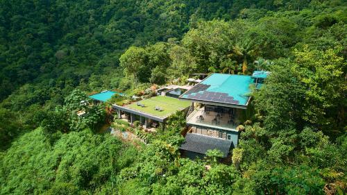 an aerial view of a house in the middle of a forest at Rancho Pacifico - Boutique Hotel for Adults in Uvita