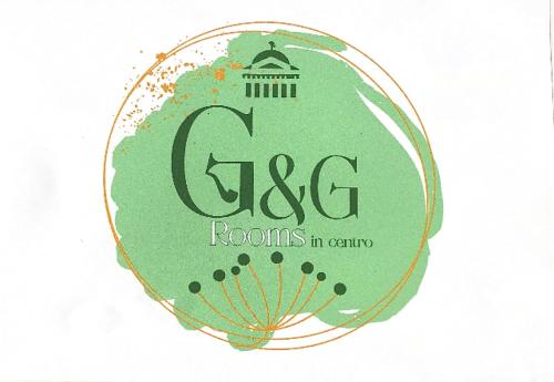 a logo for rooms in center with a building at G&G ROOMS in Palermo