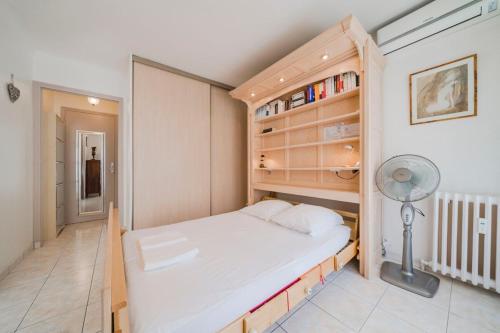 - une petite chambre avec un lit et une étagère dans l'établissement Nice studio heart of Cannes, à Cannes