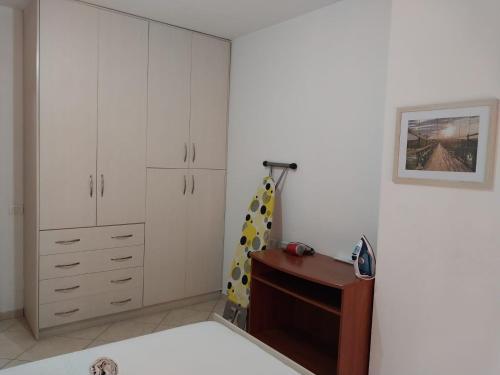 a bedroom with white cabinets and a dresser at Home Sweet Home 3 - Guest House in Tirana