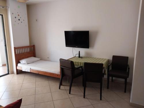 a small room with a bed and a table and chairs at Home Sweet Home 3 - Guest House in Tirana