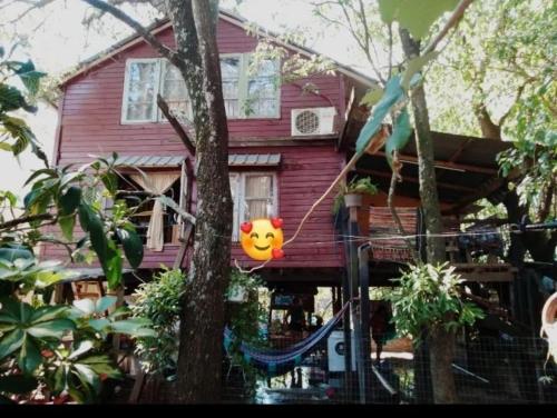 a house with a clown balloon hanging from a tree at Cabaña dos pisos in Artigas