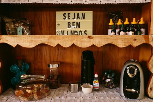 a shelf in a kitchen with bottles of beer at Pousada Mirante dos Ipês - Capitólio - MG in Capitólio