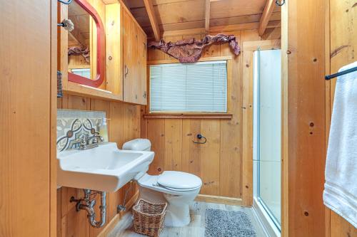 a bathroom with a white toilet and a sink at Cozy Mi-Wuk Village Cabin 18 Mi to Dodge Ridge! in Mi-Wuk Village