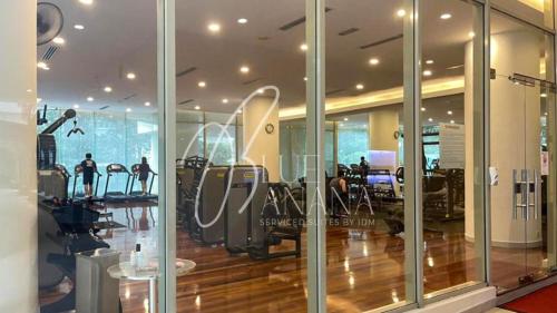 a gym with treadmills and exercise equipment in a building at Luxury Signature Suites, KLCC by BlueBanana in Kuala Lumpur