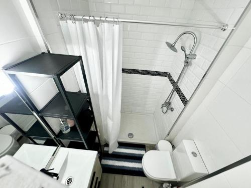a bathroom with a shower and a toilet and a sink at Ocean Breeze Oasis in Puerto de la Cruz in Puerto de la Cruz
