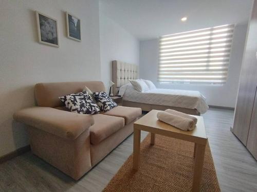 a living room with a couch and a bed at Apartamento de Estudio en Bogotá, Casco central in Bogotá