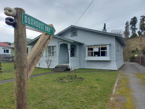 a house with a street sign in front of it at DuxHouse BnB in Taihape