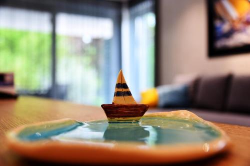a small plastic cone on a plate on a table at Olive Apartman in Alsóörs