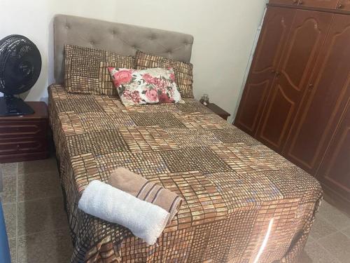 a bedroom with a bed with a pillow on it at Perfeita Cobertura no Flamengo in Rio de Janeiro
