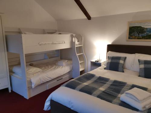 a small bedroom with a bunk bed and a bed at Skipton House Annex in Thirsk