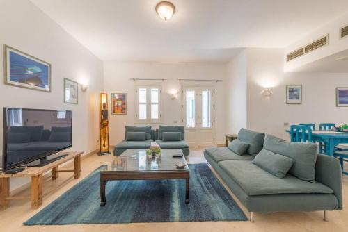 a living room with a couch and a table at Abutig Marina flat ground floor in Hurghada