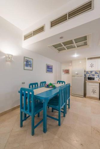 a blue table and chairs in a kitchen at Abutig Marina flat ground floor in Hurghada