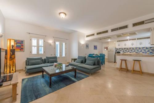 a living room with couches and a table and a kitchen at Abutig Marina flat ground floor in Hurghada
