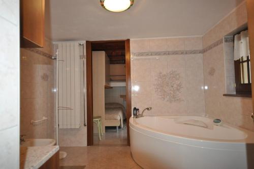 a bathroom with a tub and a sink at Cat Marvei in Villadossola