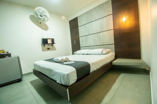 a bedroom with a bed with two teddy bears on it at Hotel Panorama Medellín in Medellín