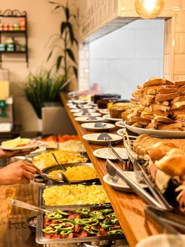a buffet line with many different types of food at HMG Rio Suítes in Rio de Janeiro