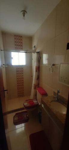 a bathroom with a shower and a sink and a toilet at A Casa Branca in Rio das Ostras