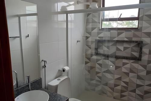 a bathroom with a shower and a toilet and a sink at Apartamento em São Pedro 305 in Juiz de Fora