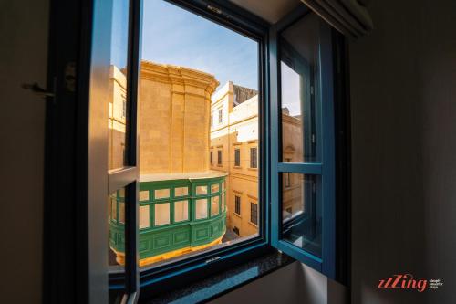 an open window with a view of a building at Avalon Boutique in Valletta