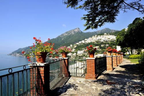 a fence with flowers on it next to the water at Domus Antonina in Vietri sul Mare