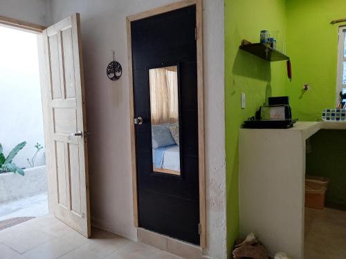 una habitación con una puerta y una cama en ella en Casa Chen-Huaye, en Isla Mujeres
