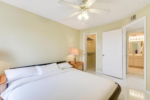 a bedroom with a white bed and a ceiling fan at Houston Vacation Rental about 1 Mi to NRG Stadium! in Houston