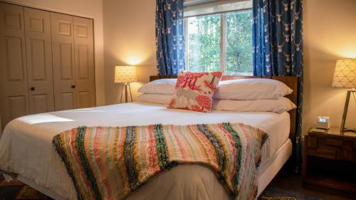 a bedroom with a large bed with a window at Elk Street Retreat - Near Glacier Park in Columbia Falls