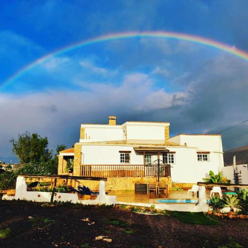 a rainbow in the sky above a house at Casa Elsa in Puerto del Rosario