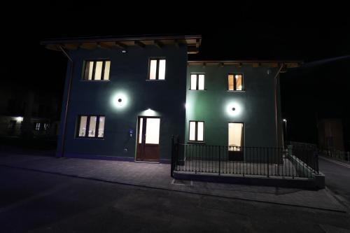 a blue building with a door at night at Il Fienile in Magliano Alpi
