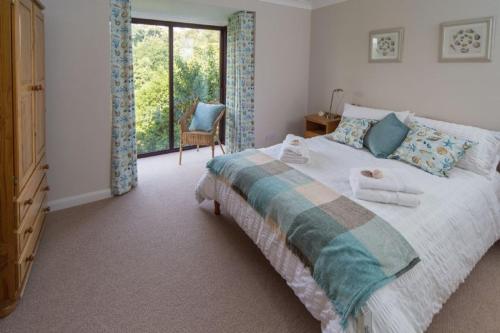 a bedroom with a large bed and a window at The Ridge in Dartmouth