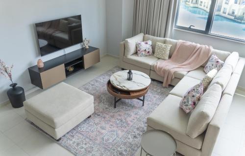 a living room with two couches and a tv at Downtown Oasis, Burj Khalifa Views, Luxury Amenities in Dubai