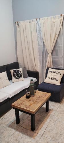 a living room with a couch and a coffee table at Finchu in Barrio Esteban Echeverría