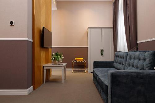 a living room with a couch and a table at Modern Art Hotel in Lviv