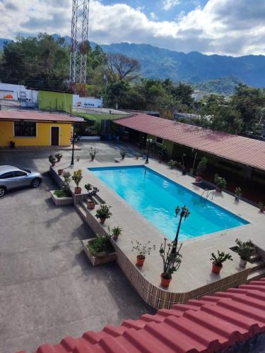 a swimming pool in a parking lot next to a building at hotel ivon in Esquipulas