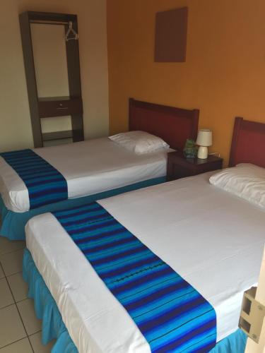 Кровать или кровати в номере Hotel Villa Margarita