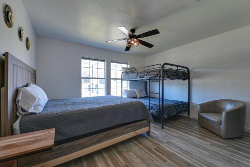 a bedroom with a bed with a ceiling fan and a chair at Little Elm Pearl Near Park and Lewisville Lake! in Little Elm