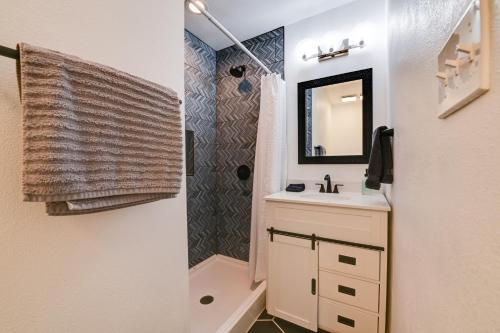 a bathroom with a shower and a sink and a mirror at Little Elm Diamond - Steps to Lewisville Lake! in Little Elm