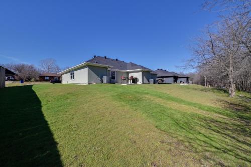 a house on a hill with a large yard at Little Elm Diamond - Steps to Lewisville Lake! in Little Elm