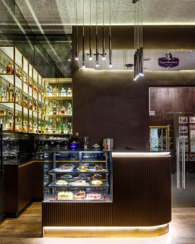 a restaurant with a counter with food on display at Modern Art Hotel in Lviv