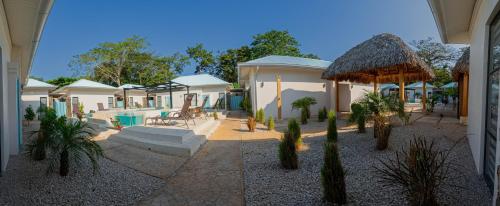 two pictures of a house with a yard with cactus at Villas VR Beachwalk Avellanas in Playa Avellana
