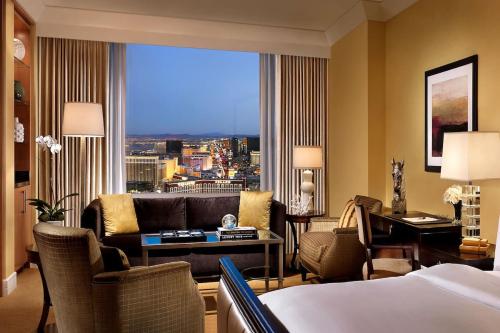 a hotel room with a bed and a couch and a window at Trump International Hotel in Las Vegas