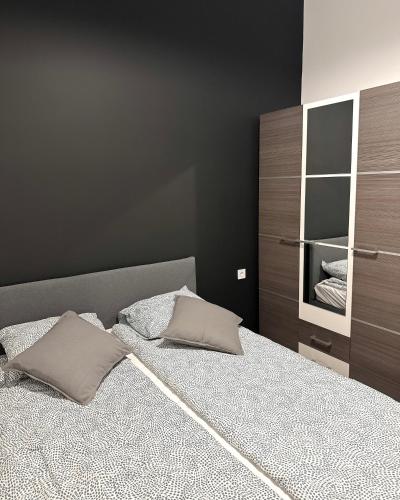 a bedroom with a bed with two pillows on it at Dolce Vita Basilica in Budapest