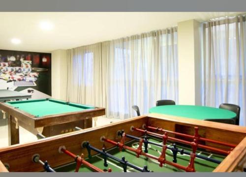 a room with two tables and a pool table at LUGAR INCRÍVEL - VG FUN PRAIA DO FUTUTO FORTALEZA in Fortaleza