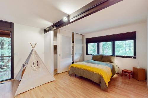a bedroom with a bed and a play tent at Mindful Forest Sanctuary in Mill Valley