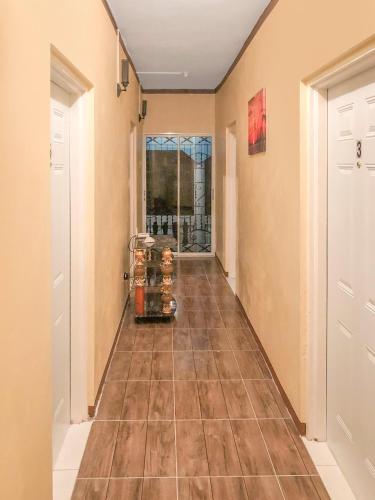 a hallway with a tile floor and two doors at SGR Near The Sea in Bull Bay