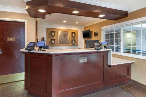 a lobby with a reception desk with laptops on it at Comfort Inn Santa Monica - West Los Angeles in Los Angeles