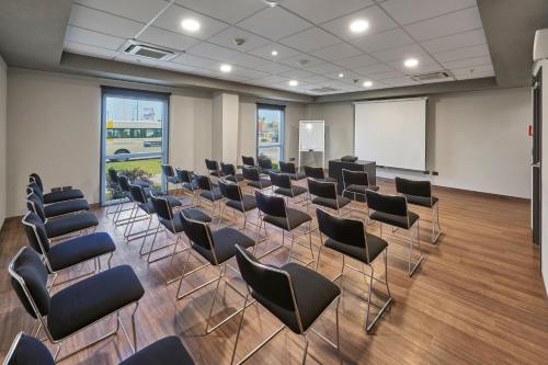 a conference room with chairs and a whiteboard at City Express by Marriott Tampico Altamira in Tampico