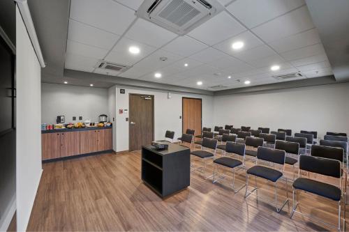 a conference room with chairs and a table and a podium at City Express by Marriott Tampico Altamira in Tampico
